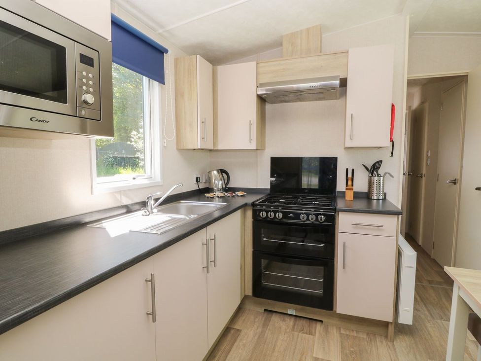 A kitchen with a stove and sink at Laughter Tor Tavistock