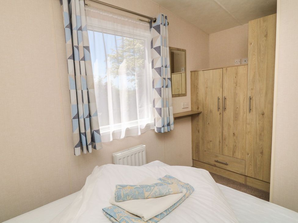 A bedroom with a bed and wardrobe at Laughter Tor Tavistock