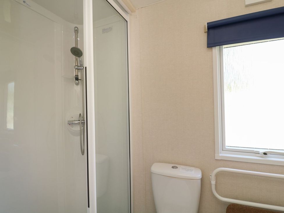 A bathroom with a shower and toilet at Laughter Tor Tavistock