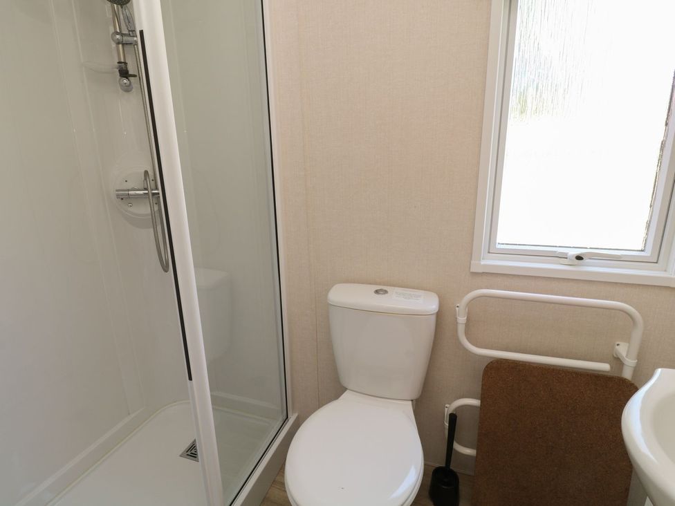 A bathroom with a shower and toilet at Laughter Tor in Tavistock
