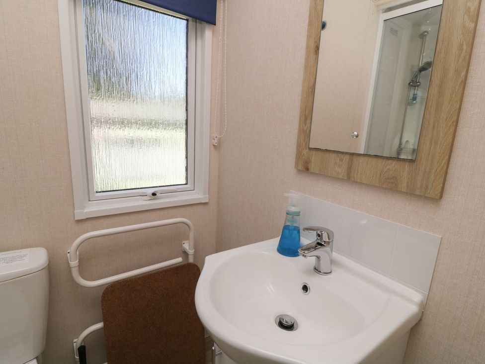 A bathroom with a toilet and sink at Laughter Tor in Tavistock