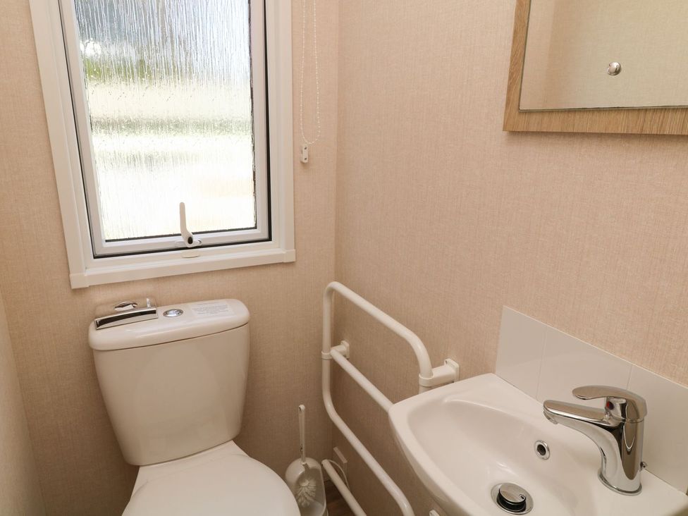 A bathroom with a toilet and a sink at Laughter Tor in Tavistock