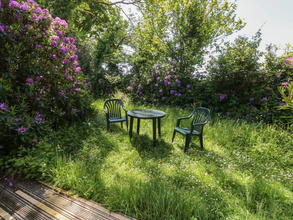 A garden with two chairs and a table at Laughter Tor Tavistock