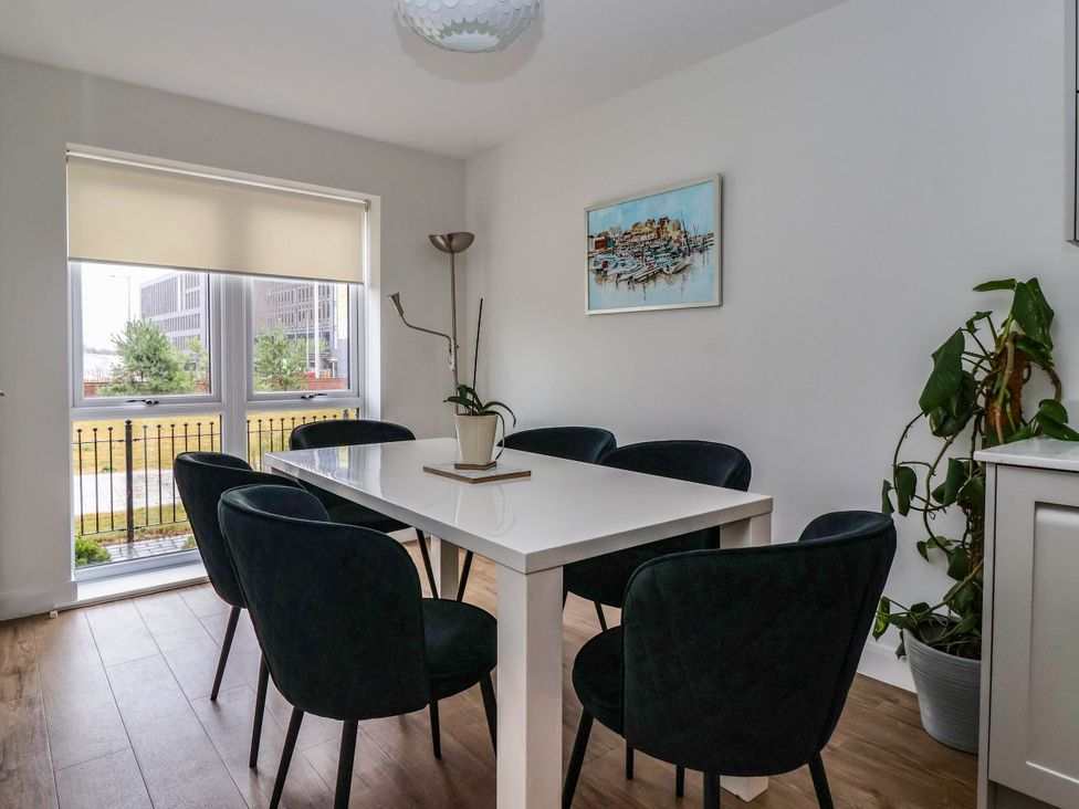 A dining room with a table and chairs at Blanket Row in Hull