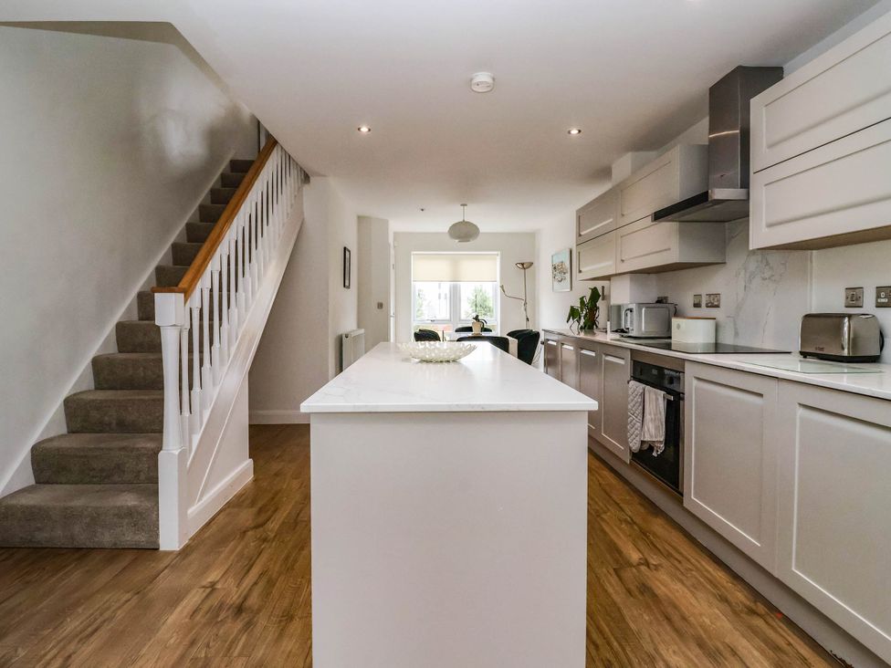 A kitchen with a staircase and kitchen island at Blanket Row in Hull
