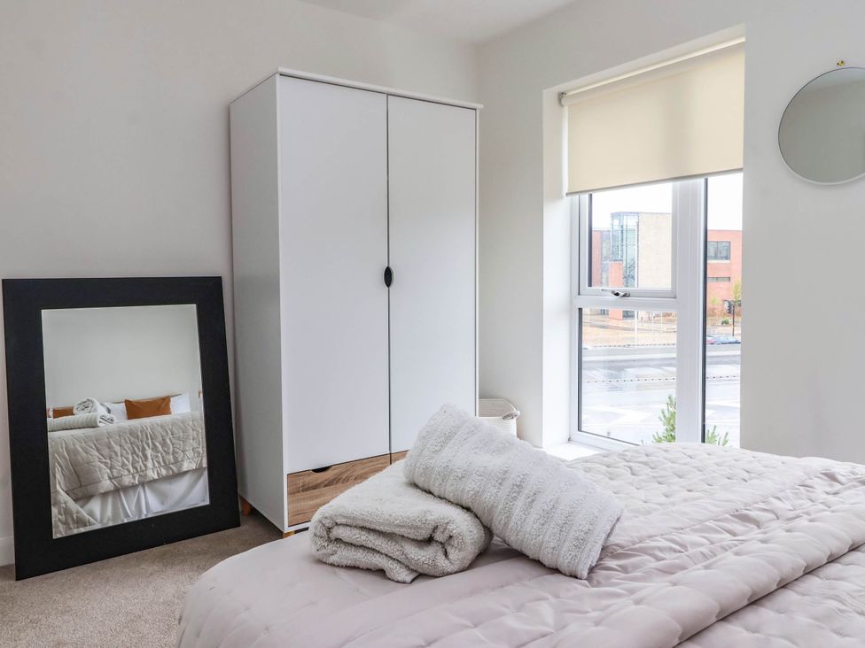 A bedroom with a bed and wardrobe at Blanket Row in Hull