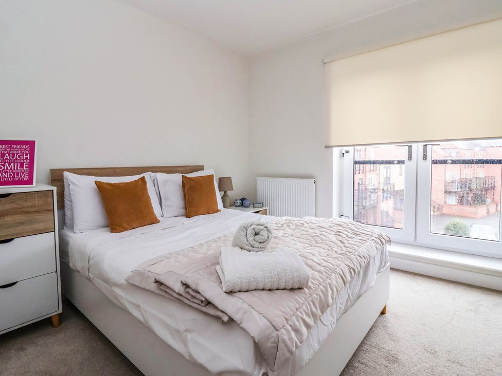 A bedroom with a bed and window at Blanket Row in Hull