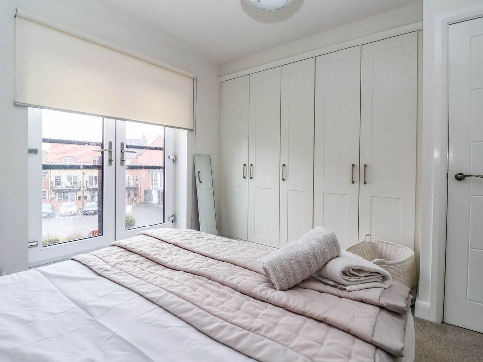A bedroom with a bed and wardrobe at Blanket Row in Hull
