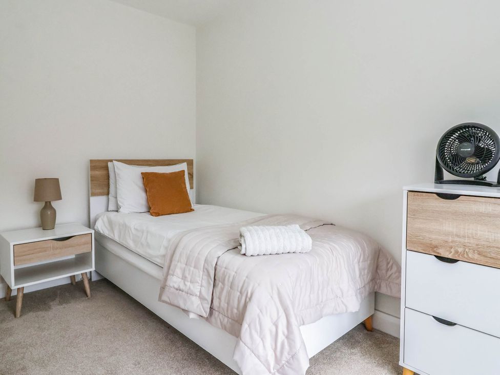 A bedroom with a single bed and nightstand at Blanket Row in Hull