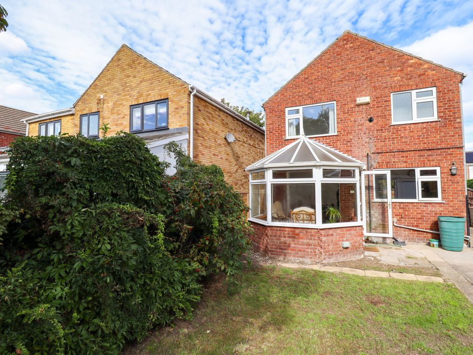 A brick house with a conservatory and garden at Mariner's Nook in Cleethorpes
