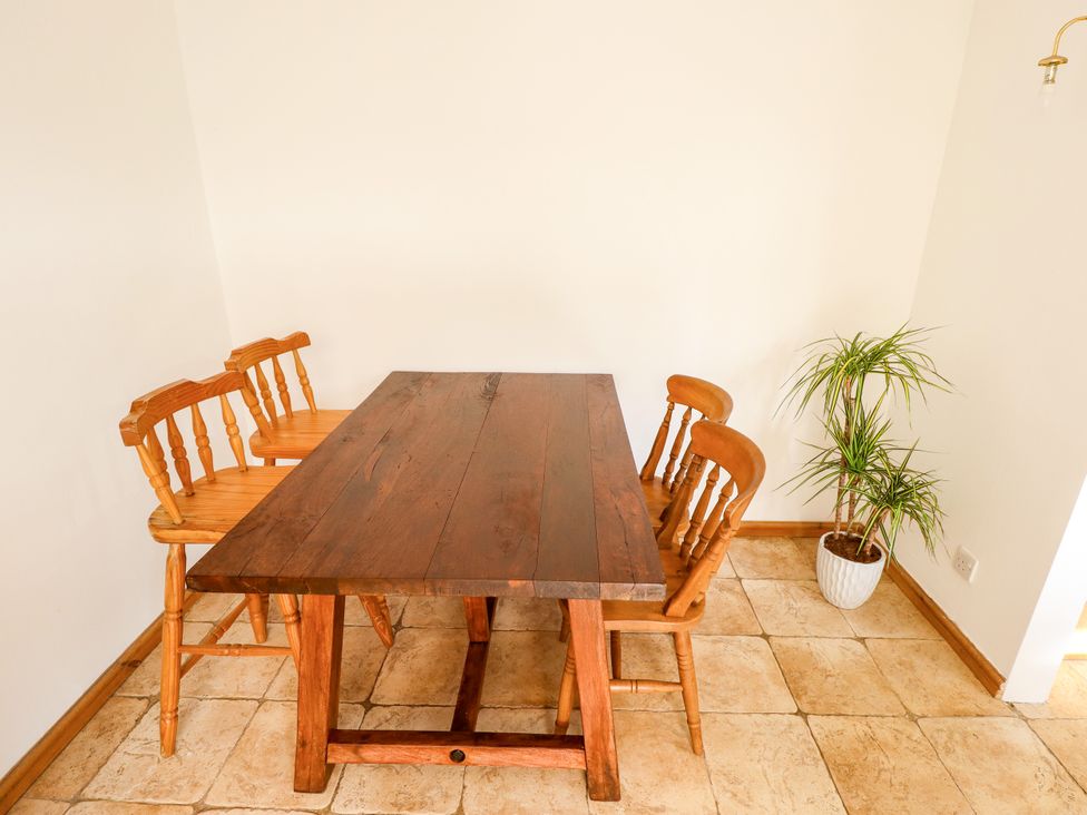 A dining room with a wooden table and chairs at Mariner's Nook in Cleethorpes