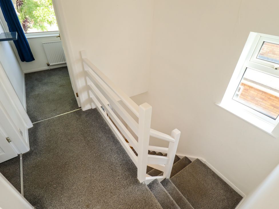 A staircase and railing in a hallway at Mariner's Nook in Cleethorpes