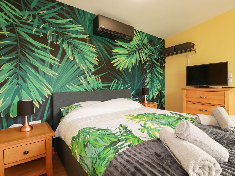A bedroom with a bed and television at The Hyde, Tazamble cottage, Launceston