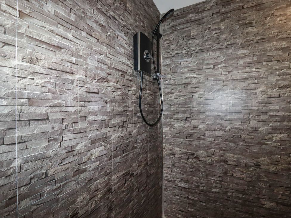 A shower with a showerhead in a bathroom at The Hyde Tazamble cottage Launceston
