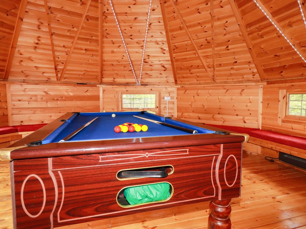 A snug with a pool table and wooden bench seating at The Hyde, Tazamble cottage in Launceston