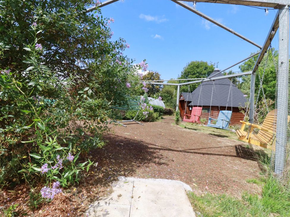 A garden with a swing set and a shed at The Hyde, Tazamble cottage in Launceston