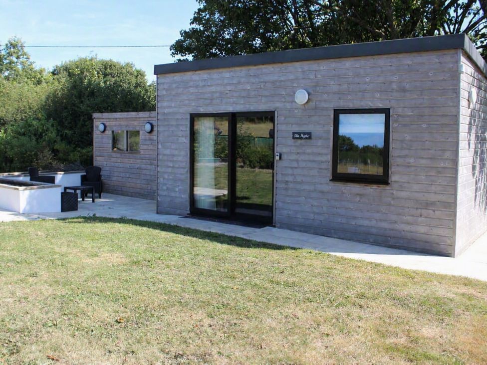 A modern building with patio and seating area at The Hyde Clubworthy near Launceston