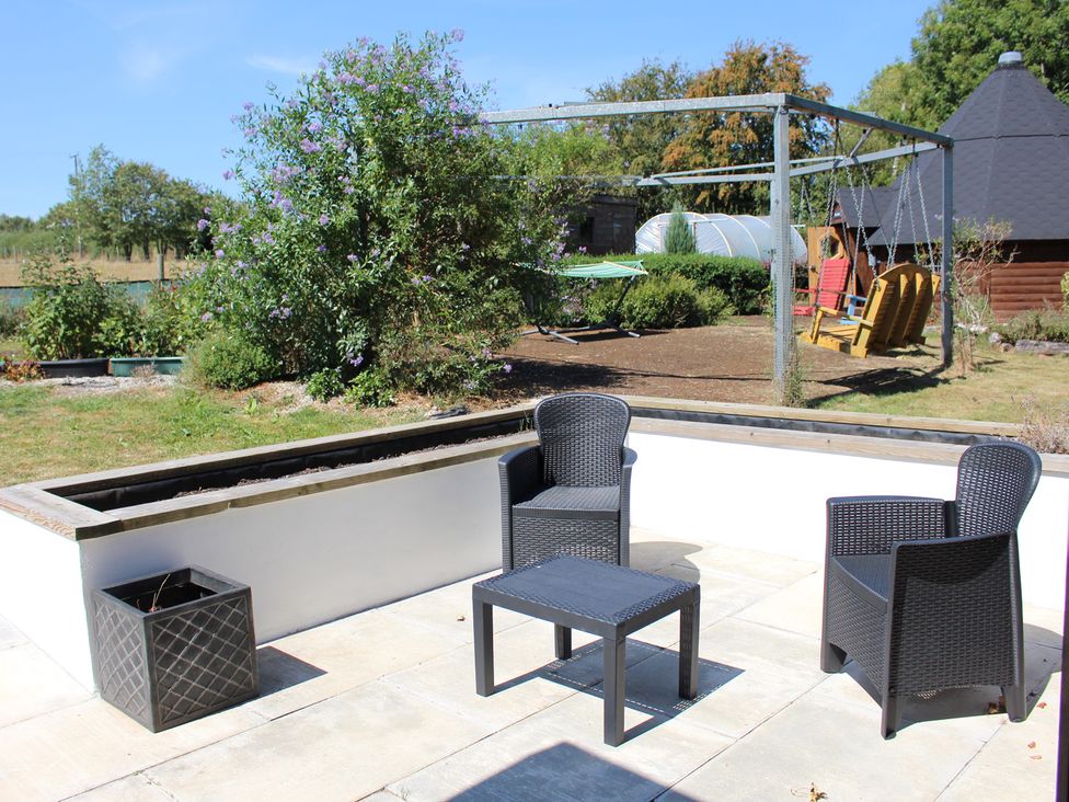 A garden with seating and a planter at The Hyde Clubworthy near Launceston