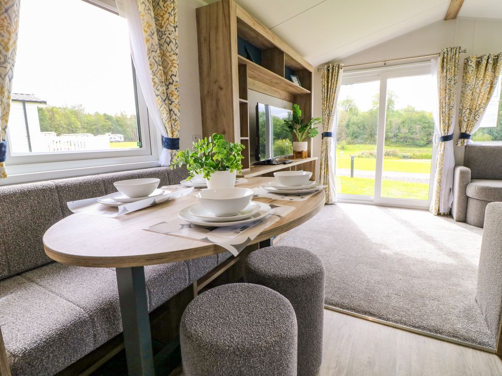 A dining area with table and chairs at Kestrel Lodge in Coalville