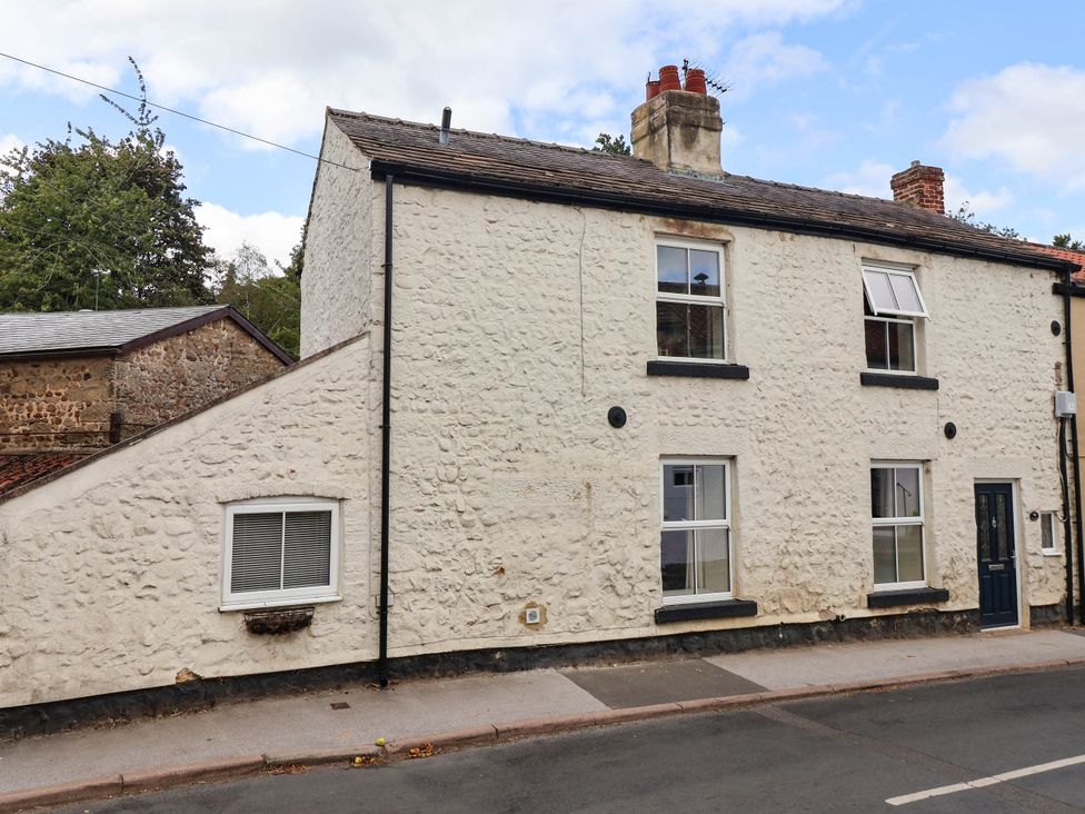 An exterior view of a house with windows and a door at Bowdery in Harrogate