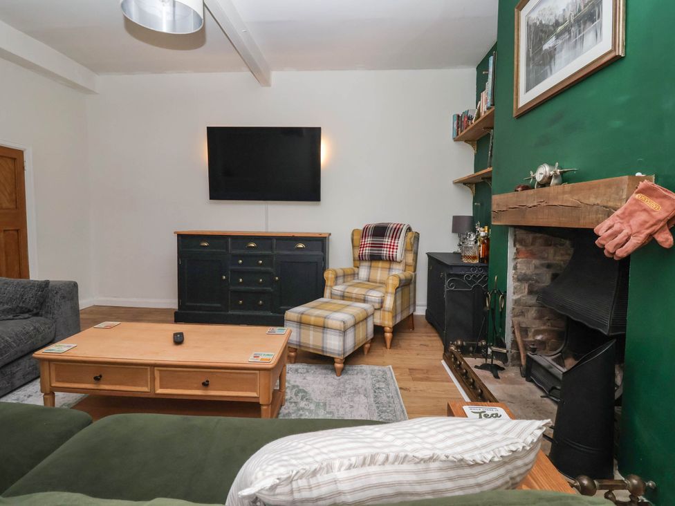 A living room with a television and fireplace at Bowdery in Harrogate