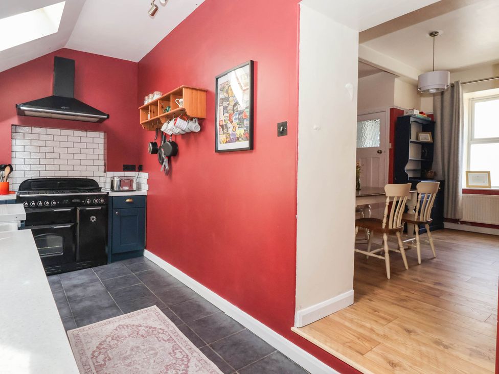 A kitchen with a stove and dining area at Bowdery in Harrogate