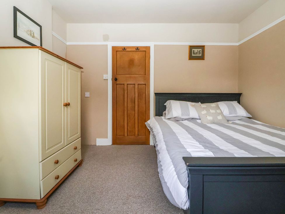 A bedroom with a bed and wardrobe at Bowdery in Harrogate