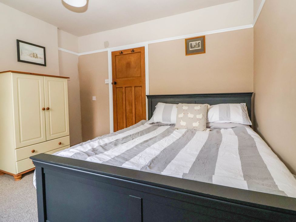 A bedroom with a bed and wardrobe at Bowdery in Harrogate