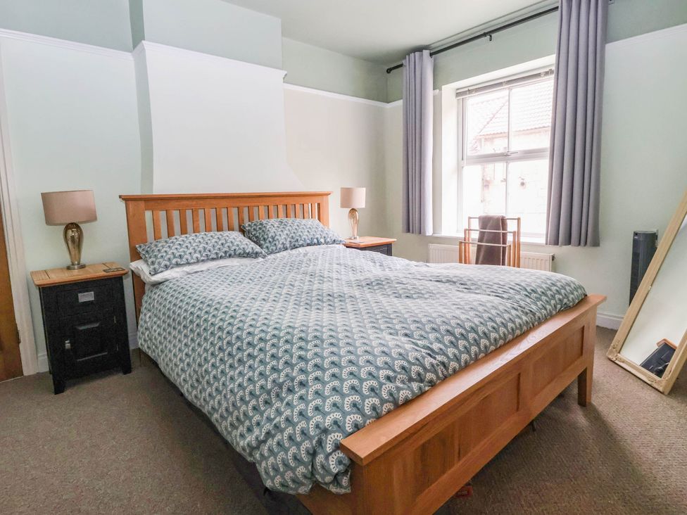 A bedroom with a bed and window at Bowdery in Harrogate