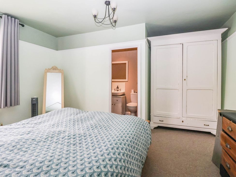 A bedroom with a bed and wardrobe at Bowdery in Harrogate