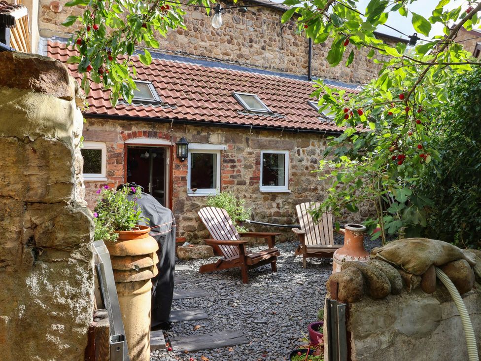 An outdoor space with wooden chairs and plants at Bowdery in Harrogate