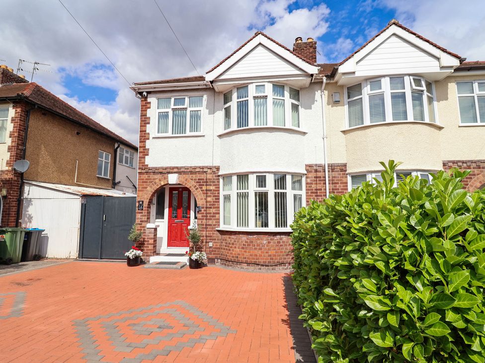 A house with red door and brick driveway at Laburnum house Ellesmere Port