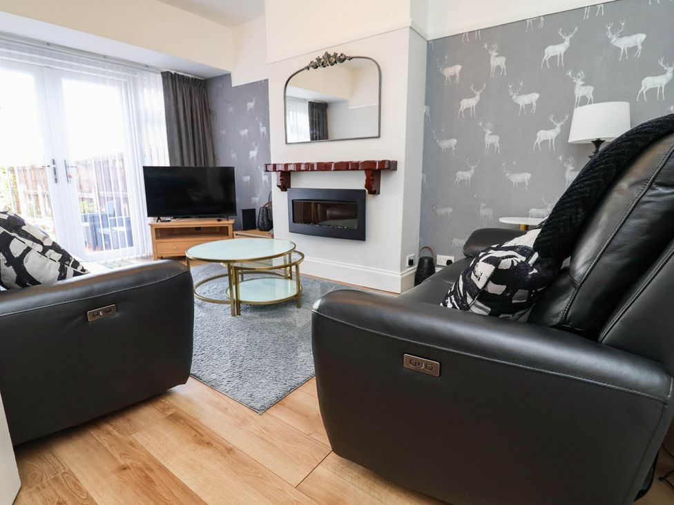 A living room with a television and coffee table at Laburnum house in Ellesmere Port