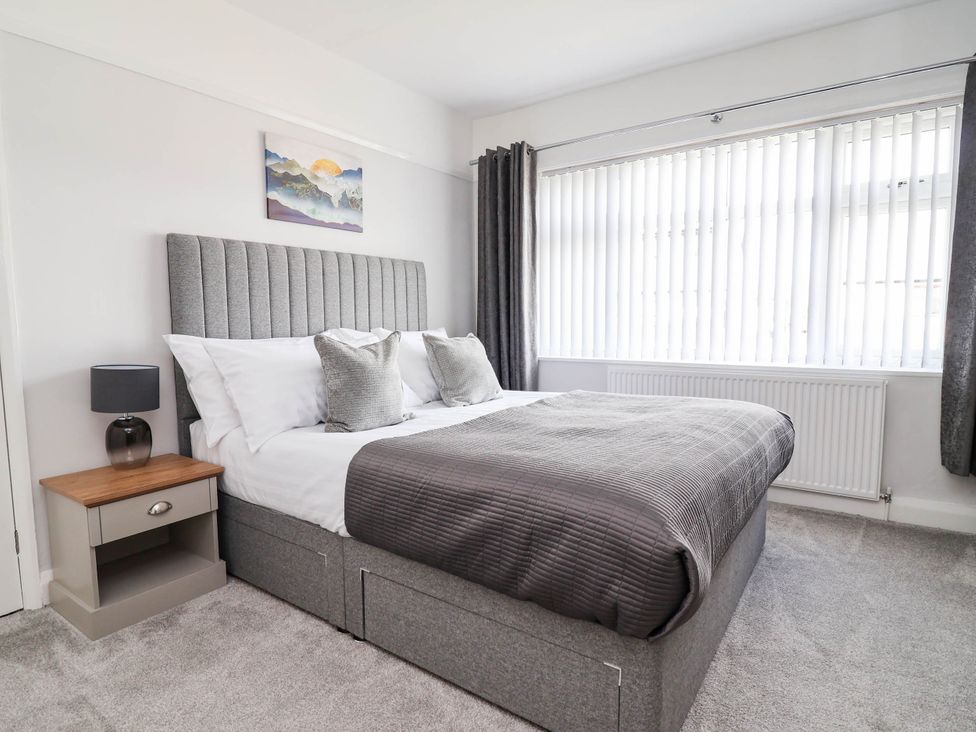 A bedroom with a bed and bedside table at Laburnum house in Ellesmere Port
