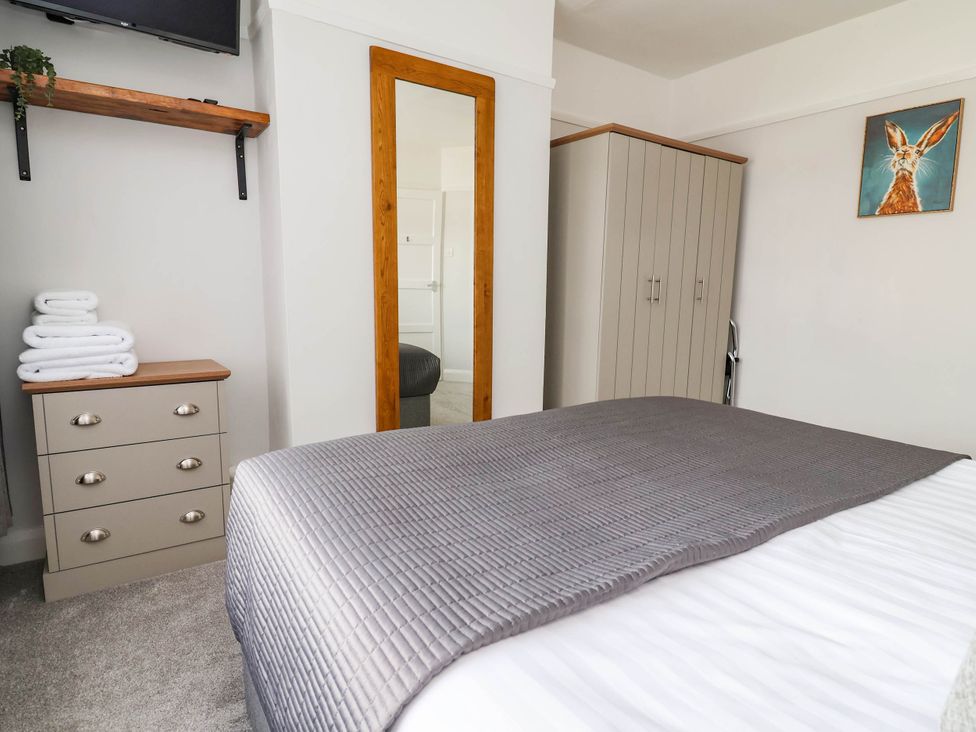A bedroom with a bed and storage furniture at Laburnum house in Ellesmere Port