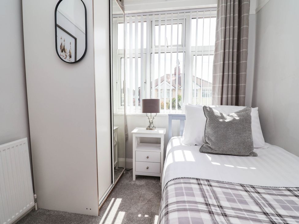 A bedroom with a bed and nightstand at Laburnum house Ellesmere Port
