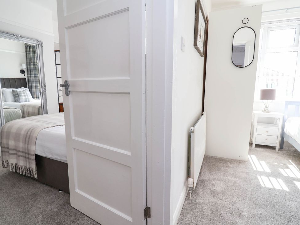 A bedroom with beds and a mirror at Laburnum house Ellesmere Port