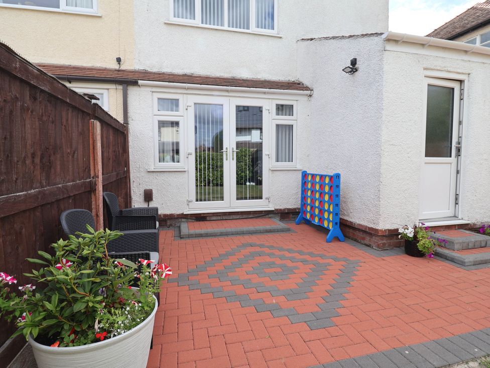 A garden area with paving stones and seating at Laburnum house in Ellesmere Port