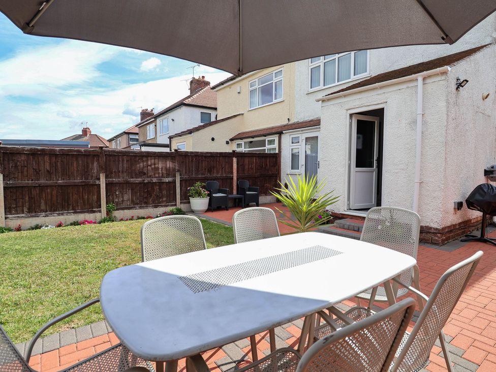 A garden area with a table and chairs at Laburnum house Ellesmere Port