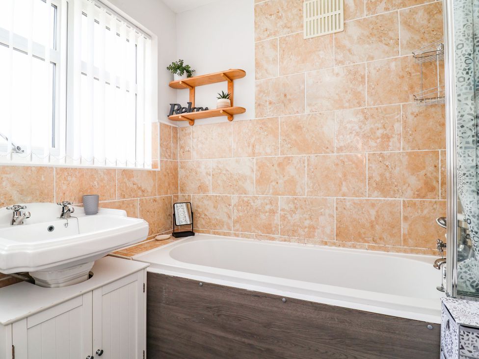 A bathroom with a sink and bathtub at Laburnum House in Ellesmere Port