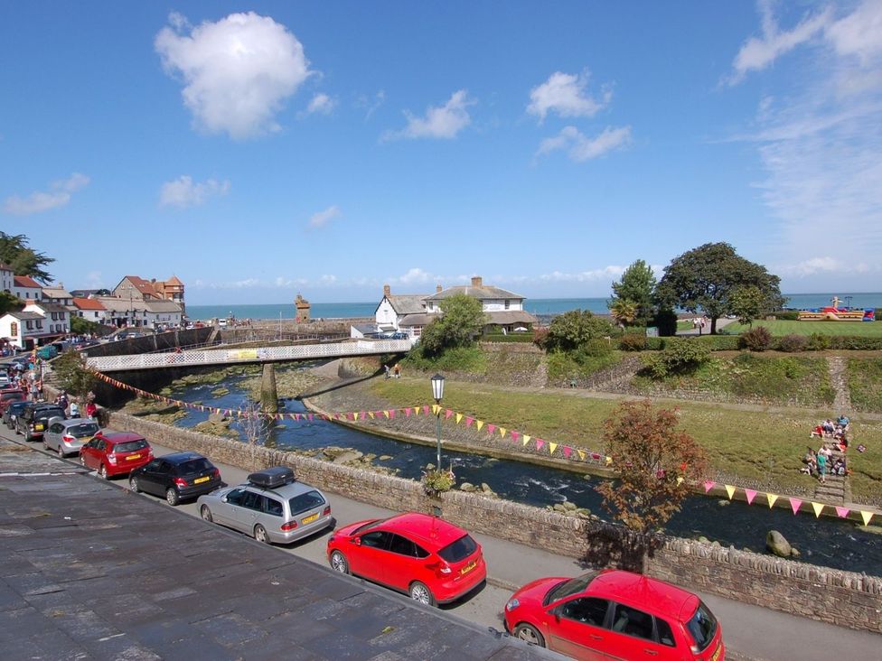 A view of a river and bridge with cars parked at Old Lyn Cottage in 