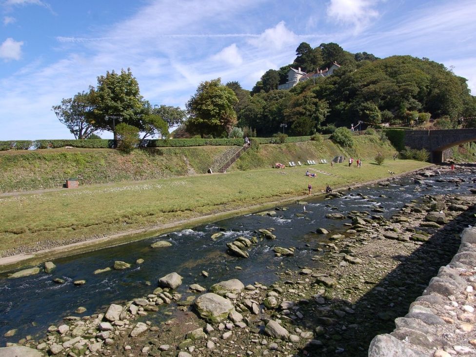 A river with grass and trees alongside at Old Lyn Cottage 