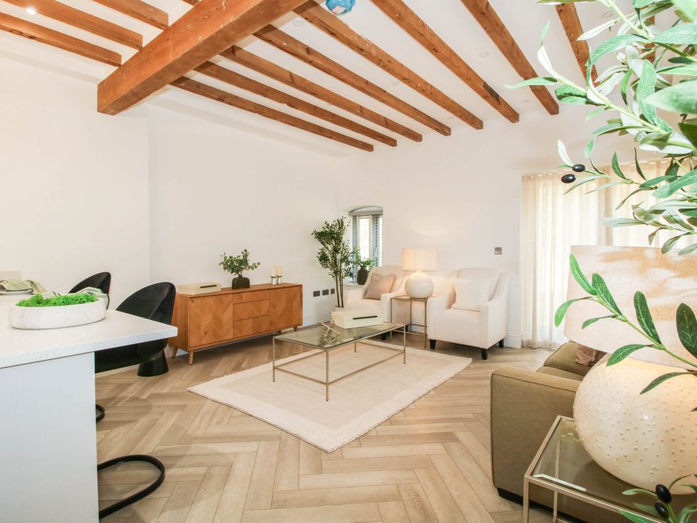 A living room with a coffee table and seating at The Hayloft in Birmingham