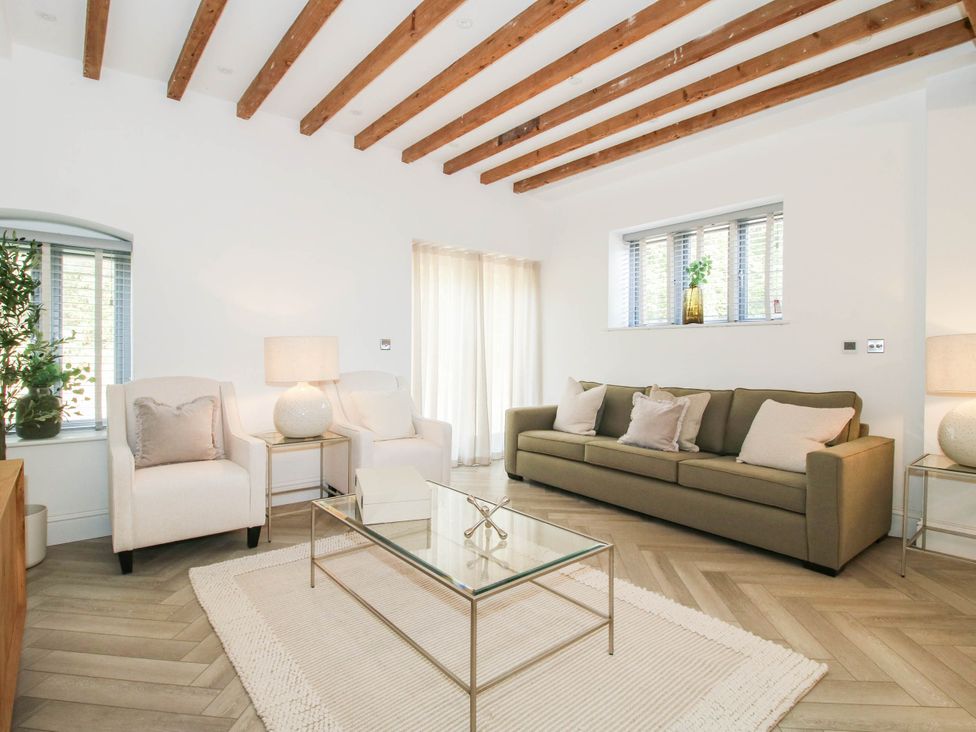 A living room with a sofa and armchairs at The Hayloft in Birmingham