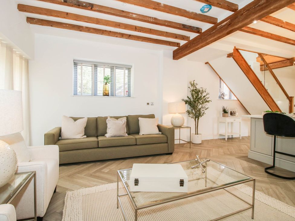 A living room with a sofa and table at The Hayloft in Birmingham
