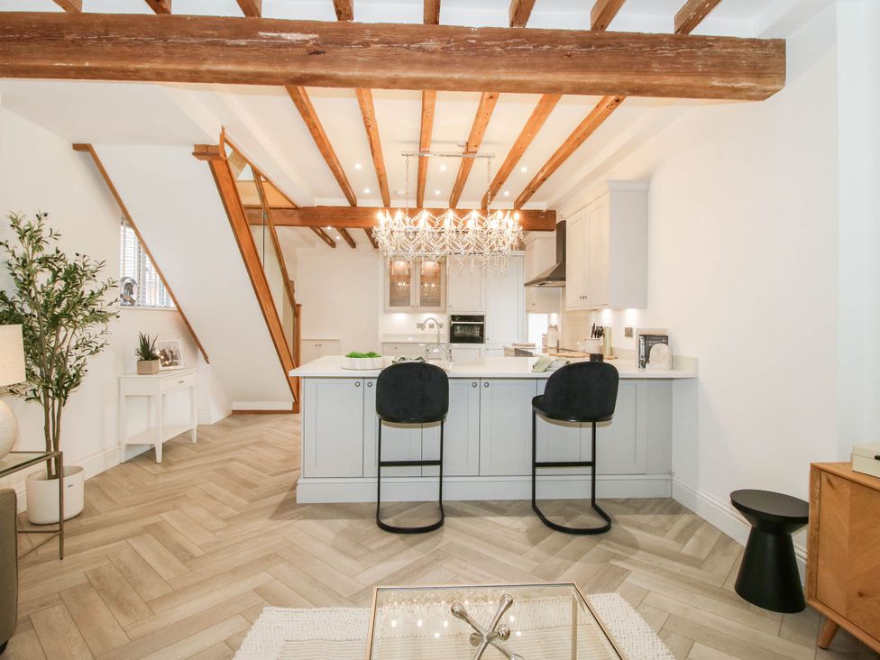 A kitchen with a counter and bar stools at The Hayloft in Birmingham