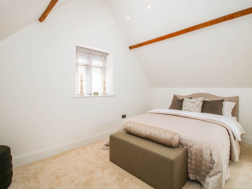 A bedroom with a bed and a window at The Hayloft in Birmingham