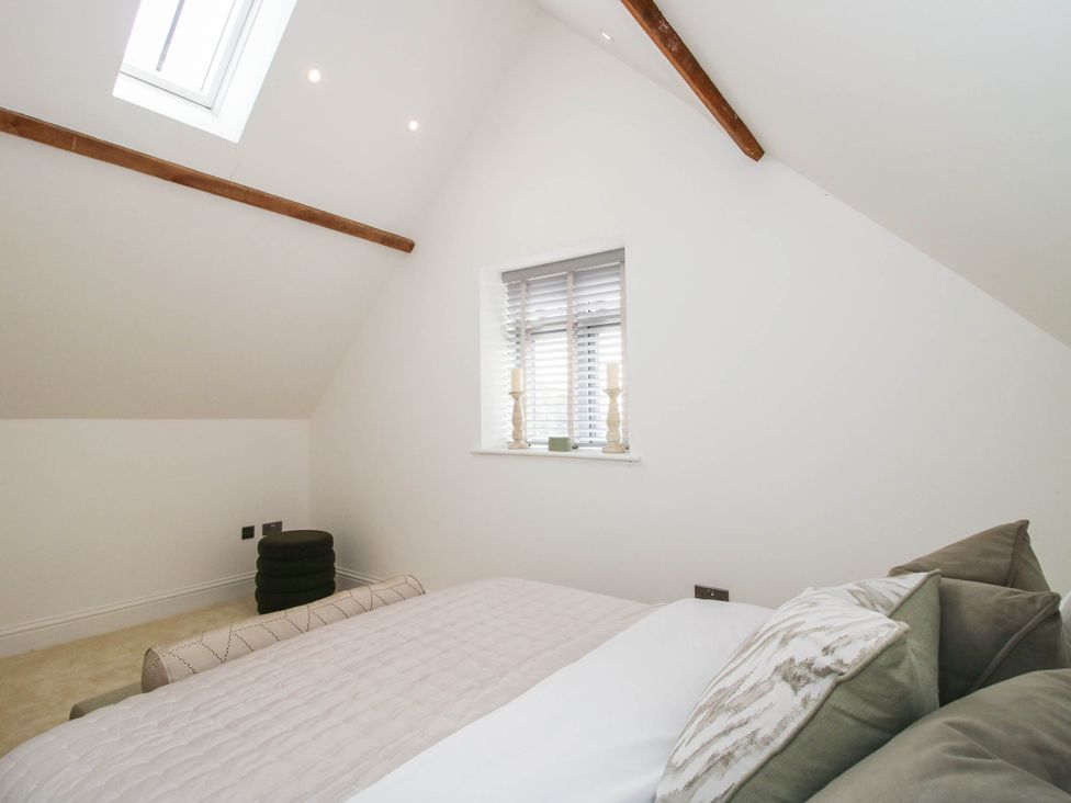 A bedroom with a bed and pillows at The Hayloft in Birmingham