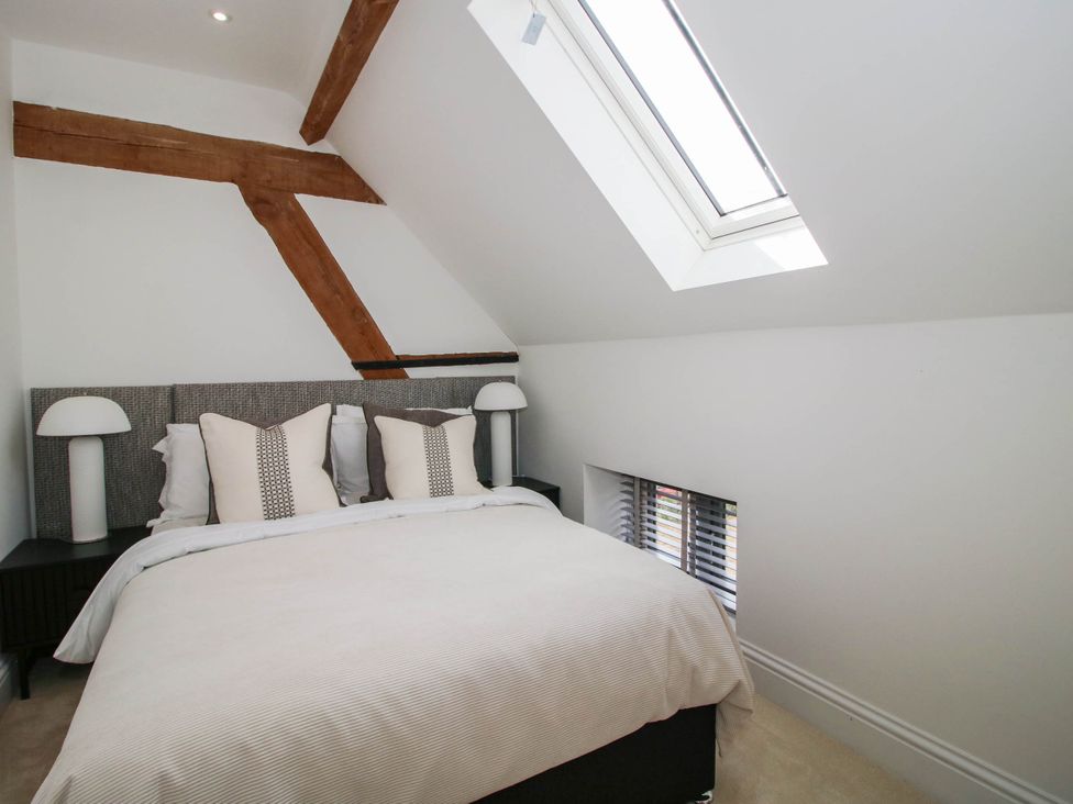 A bedroom with a bed and bedside tables at The Hayloft in Birmingham