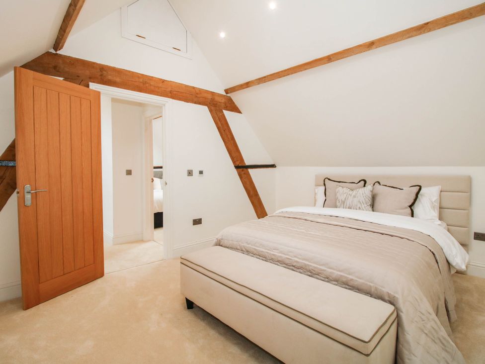 A bedroom with a door and bed at The Hayloft in Birmingham